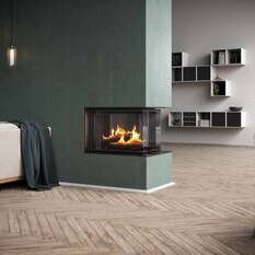 VISIO 3:1 room divider with black window & support frame Wood fireplace VISIO 3:1 are integrated into a green wall as a room divider that structures the living space