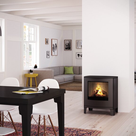 Gas stove Q-TEE 2 C with steel door on modern design feet in decorative dining room