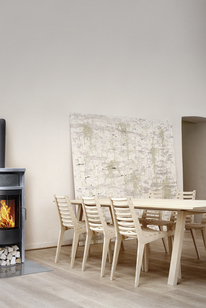 Wood stove BANDO with soapstone cladding in a minimalist living area