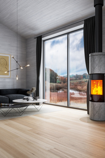 Wood stove JUNO 166 L with soapstone cladding and glass door in a large living room in grey tones