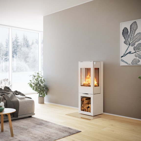 Stufa a legna NEXO 120 in bianco con porta in acciaio e due finestre laterali con modulo vano legno in un soggiorno decorativo