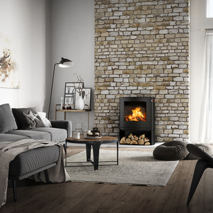 Q-TEE 2 C in black with wood compartment Wood stove Q-TEE 2 C in black with wood compartment in its slightly oval shape as fireplaces in a rustic country house